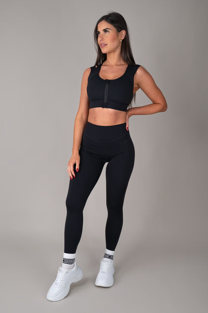 Black high support sports bra on model outfit