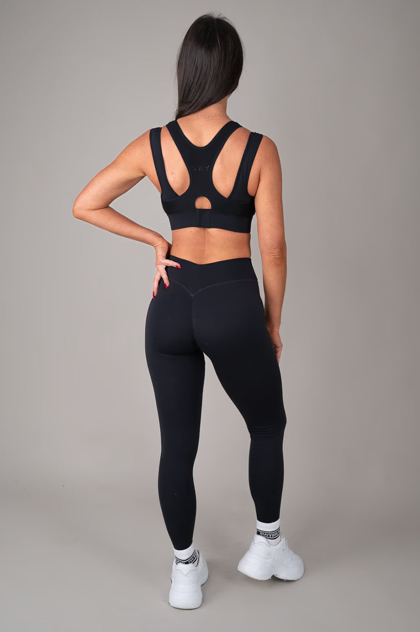 Black high support sports bra on model oufit back view